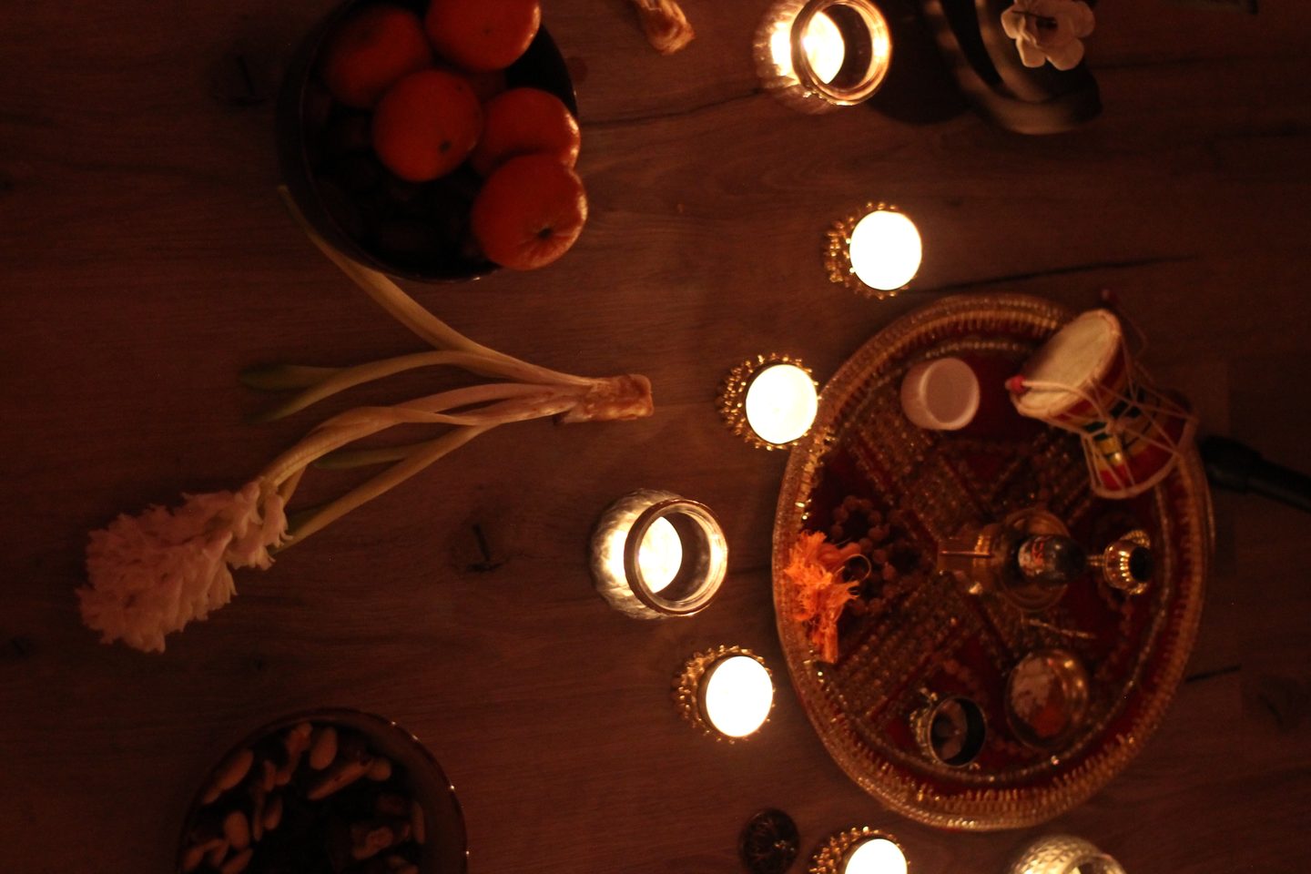 Candlelit ritual circle - offerings, flowers and warm light at a SheWhoRests gathering in Berlin