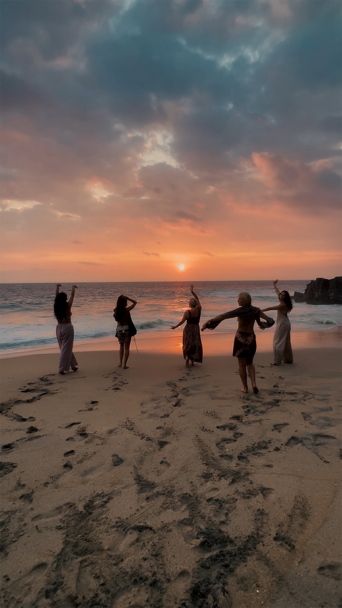Women gathered at sunset, resting in nature