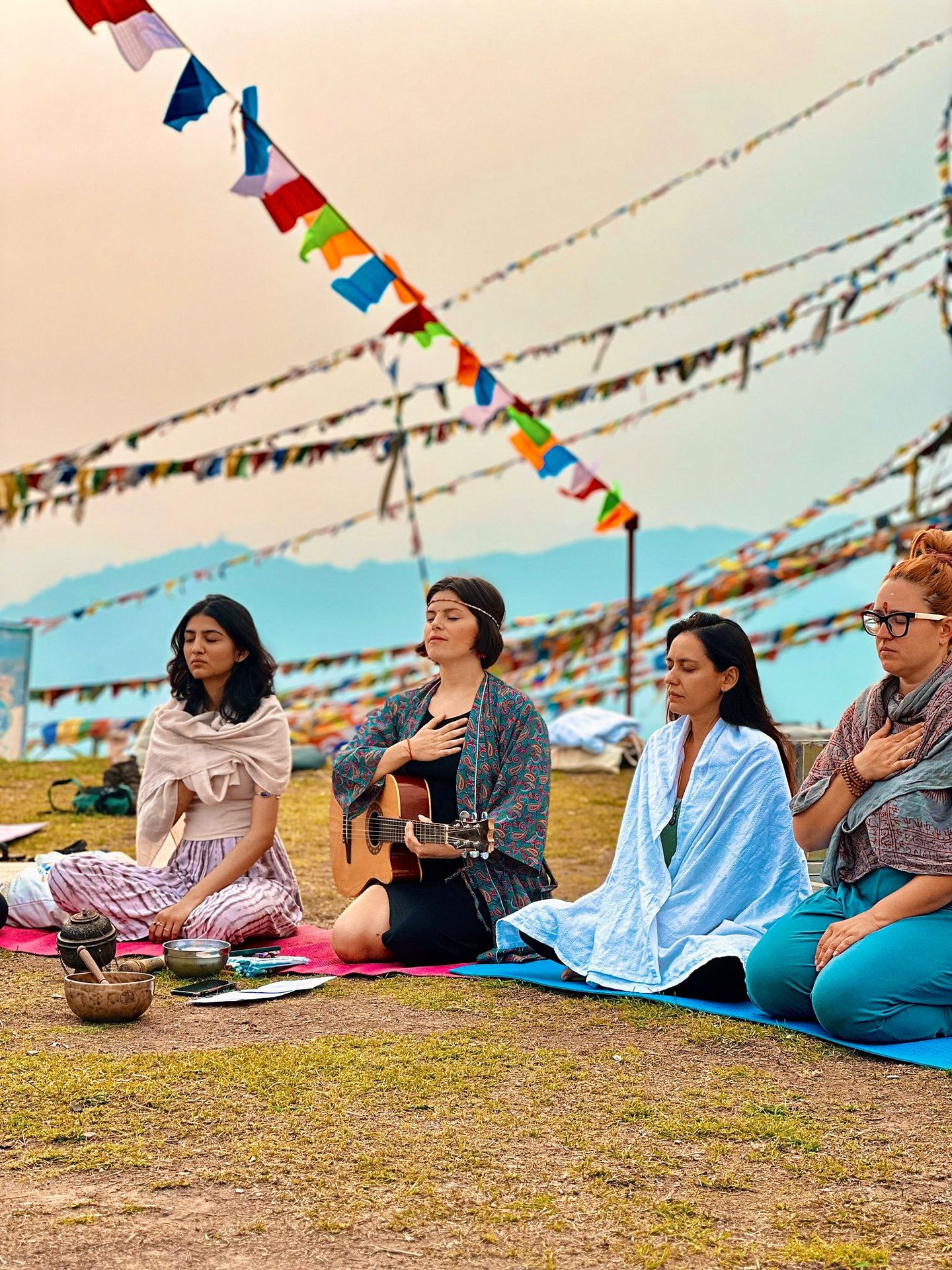 Women meditating under prayer flags